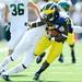 Michigan junior running back Vincent Smith is tackled by Eastern Michigan defensive back WIllie Williams during the first half against Eastern Michigan at Michigan Stadium on Saturday. Melanie Maxwell I AnnArbor.com